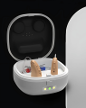 Supermini aparat słuchowy Muse 1200M RIC w etui ładującym z funkcją suszenia. Widoczne akcesoria: wkładki douszne, szczoteczka, kabel USB-C. Dyskretny model RIC dla osób z lekkim i umiarkowanym ubytkiem słuchu.